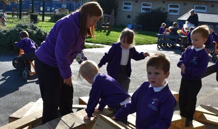 Children using wooden block outside