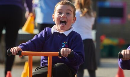 Child riding a bike and laughing