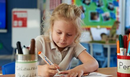 Child concentrating on her writing