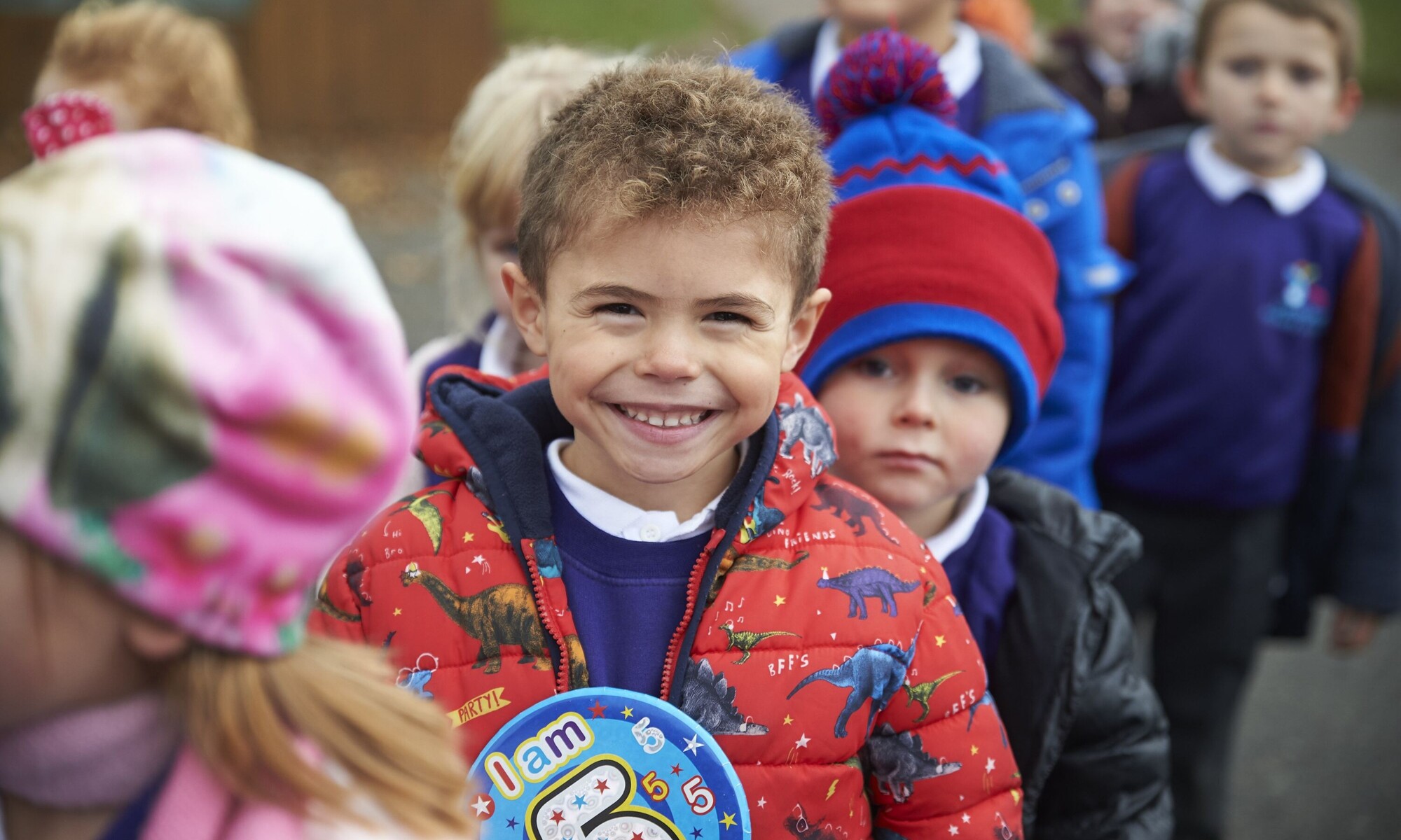 Smiling children lining up for class